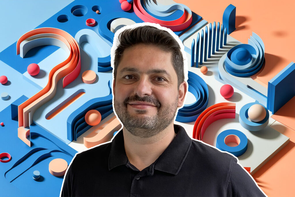 Igohr Schultz wearing a black shirt in front of an abstract background of colors and shapes